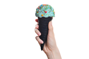 Woman's hand holding black wafer cone with blue ice cream. Isolated on white.