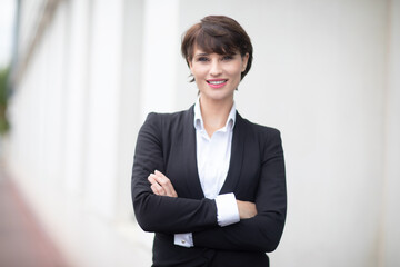 portrait of a woman working in an office posing in front of her business