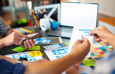 Team website designers discuss mobile application design.