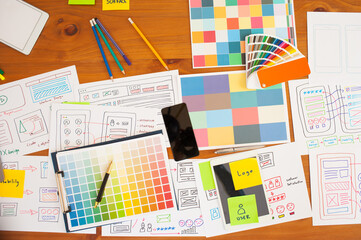Layout and color samples for website and application design. Top view of a web designer's desk.