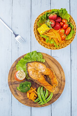 Salmon steak on wooden plate