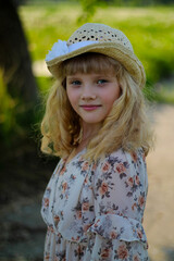 Beautiful girl in a hat, portrait in a summer park