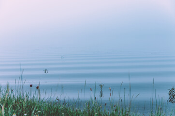 Misty morning view of hypnotising ripple waves in river with blue tint