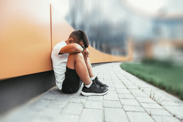 child  in depression is sitting on the floor doesn't want back to school