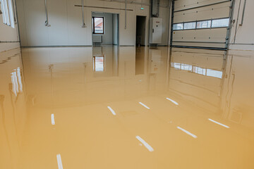 Epoxy resin applied to the floor. Industrial hall with colored floor