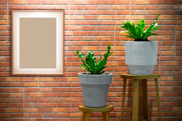 Photo frame mockup hanging on brick wall decorated with house plant.