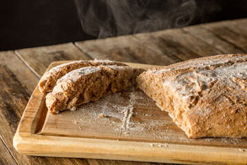 freshly baked homemade bread on wooden background 