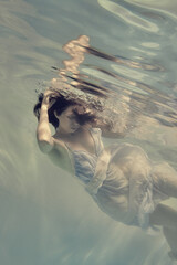 Portrait of a girl in a dress under water in bright colors
