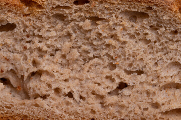 round single loan of brown bread on the stone concrete dark grey background