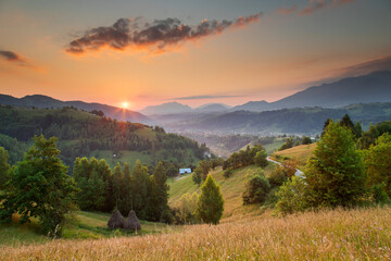 Fototapeta na wymiar Summer sunrise in the Transylvanian village