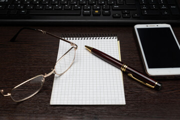 Laptop with office supplies crumpled paper on wooden desk background view from above business concept