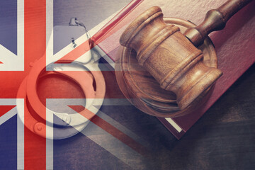 Judge gavel, handcuffs and legal book on wooden table, collage with United Kingdom flag