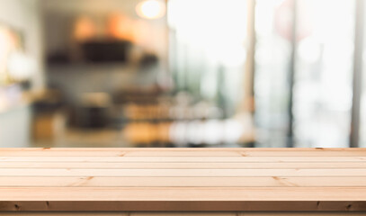 Empty wooden table top with lights bokeh on blur restaurant background