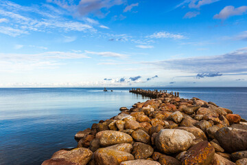 Breakwater in calm, blue Baltic sea, Latvia, on a sunny day.