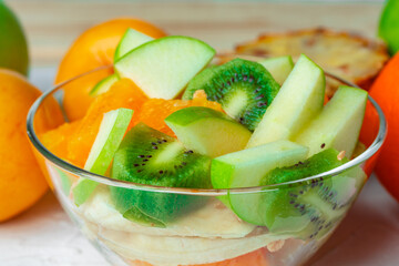 Glass bowl with fresh fruit pieces close up