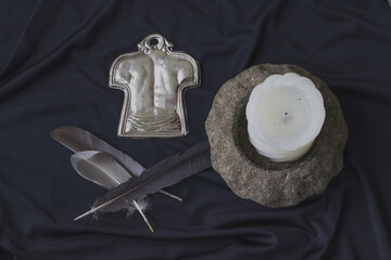 Occultism symbolic objects, human figures, bird feathers, candle