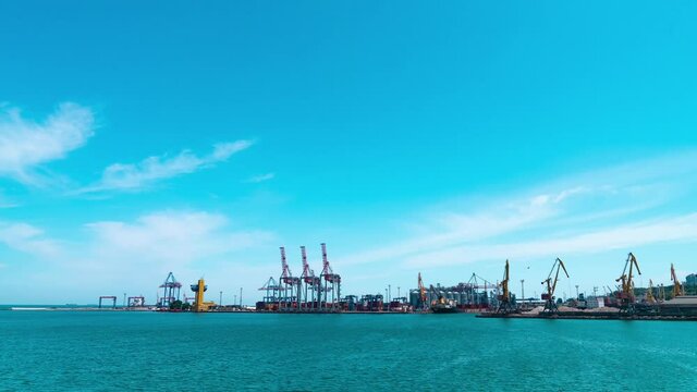Commercial Sea Port, work loading cargo by cranes with clouds in Odessa, Ukraine time lapse.
