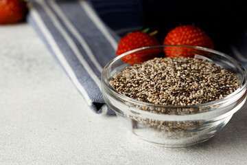 Bowl with raw chia seeds close up