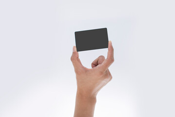 Close up of man's hand holding blank black card. Studio shot isolated on white.