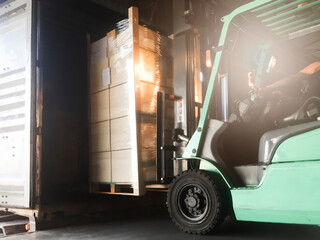 Forklift loading shipment boxes on pallet into container shipping truck. Cargo freight, Logistics...