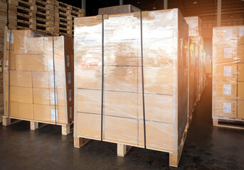 Stack of packaget boxes on wooden pallets at interior warehouse storage. Shipment cargo export. Warehouse industry logisics and transport.