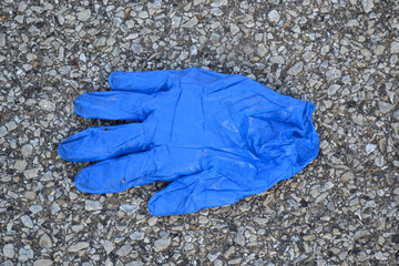 A Blue Coronavirus Glove on the Ground