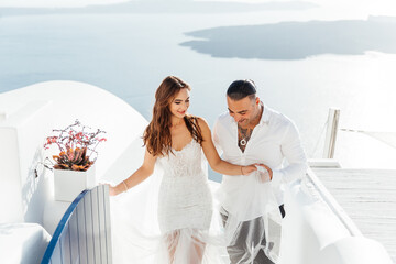 Wedding on Santorini island in Greece, beautiful couple, bride in a white wedding dress. White...