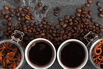 White coffee cup with with beans on dark surface