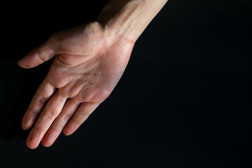 Fototapeta premium Opening hand on black background, Right hand of Asian woman, Dark tone