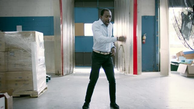 It's Quitting Time! The Workday Is Done And It Feels So Good. Manager Dances As The Whistle Blows. Ecommerce Warehouse Manager. Shot In 4k. 