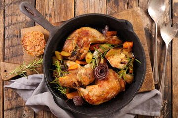 baked chicken leg with vegetables in casserole