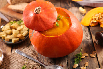 pumpkin soup with crouton on wood background