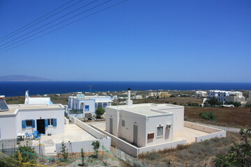snow-white houses stand on a mountain on the island of Santorini. View of the sea 