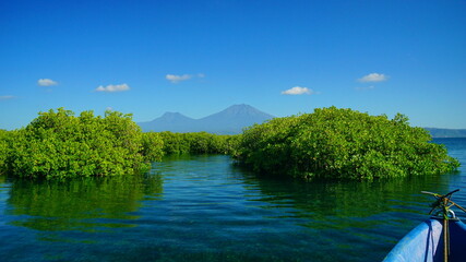 A view from Bali strait to Java island. Bali Strait is a stretch of water separating Java and Bali while connecting the Indian Ocean and the Bali Sea. 