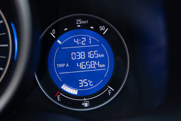 close-up digital gauge meter on car dashboard