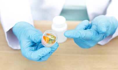 pills in the hands of a doctor close-up. Treatment concept