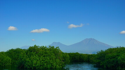 A view from Bali strait to Java island. Bali Strait is a stretch of water separating Java and Bali while connecting the Indian Ocean and the Bali Sea. 