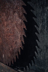 Brutal rusty saw is idle and waiting in the wings