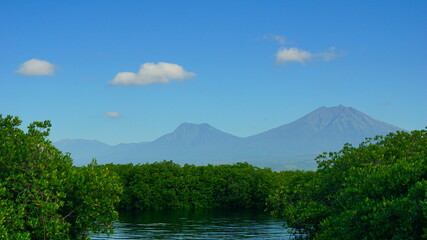 A view from Bali strait to Java island. Bali Strait is a stretch of water separating Java and Bali while connecting the Indian Ocean and the Bali Sea. 