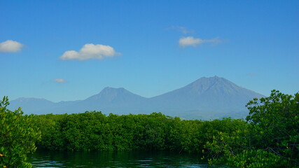 A view from Bali strait to Java island. Bali Strait is a stretch of water separating Java and Bali while connecting the Indian Ocean and the Bali Sea. 