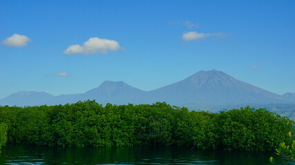A view from Bali strait to Java island. Bali Strait is a stretch of water separating Java and Bali while connecting the Indian Ocean and the Bali Sea. 
