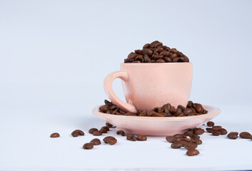 Coffee beans in a cup on a white background