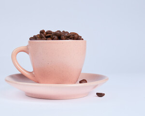 Coffee beans in a cup on a white background