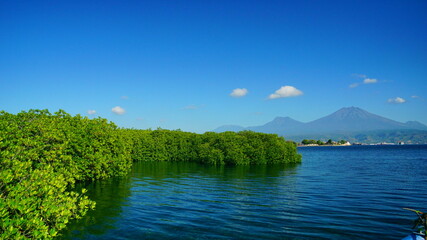 A view from Bali strait to Java island. Bali Strait is a stretch of water separating Java and Bali while connecting the Indian Ocean and the Bali Sea. 