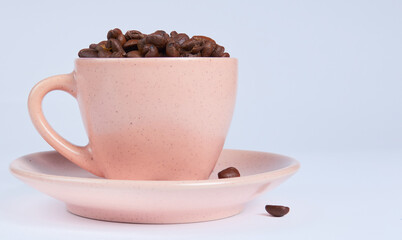 Coffee beans in a cup on a white background