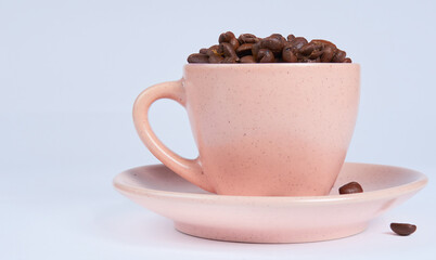 Coffee beans in a cup on a white background