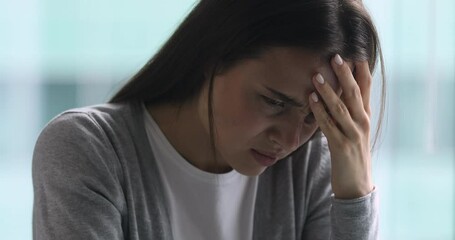 Upset sick young woman coping with terrible headache feel migraine, stressed tired girl frustrated suffer from pain ache pressure touching aching sore head at home office concept, face close up view - Powered by Adobe