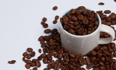 Coffee beans in a cup on a white background