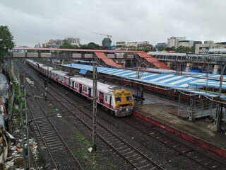 Mumbai, Maharashtra/India- June 30 2020:  Fast local train travelling on the railway track.