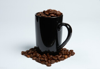 Coffee beans in a cup on a white background